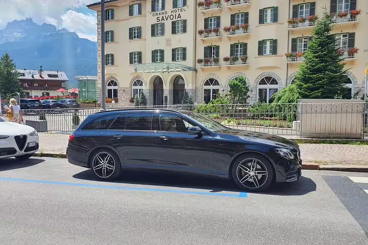 Sleek black Mercedes E-Class estate car parked outside Grand Hotel for Oslo Airport to Trysil transfer