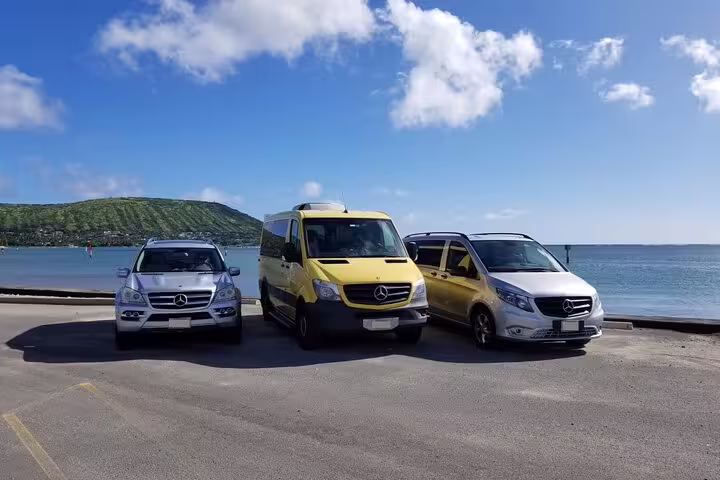 Mercedes fleet of vehicles parked by Nassau waterfront offering private cruise port transfers to Nassau hotels