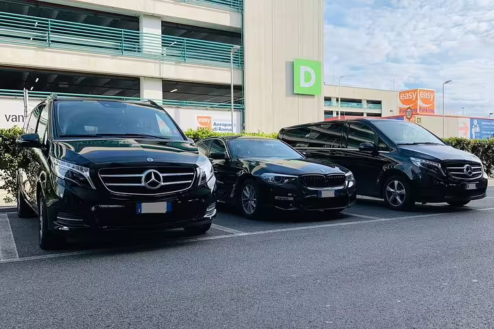 Luxury black Mercedes vans and sedan parked at airport for private transfer from Girona Airport GRO to Palamos