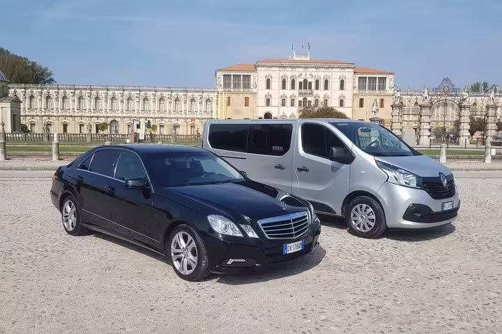 Luxury Mercedes sedan and silver minivan ready for private transfer from Malaga to AGP Airport departure service