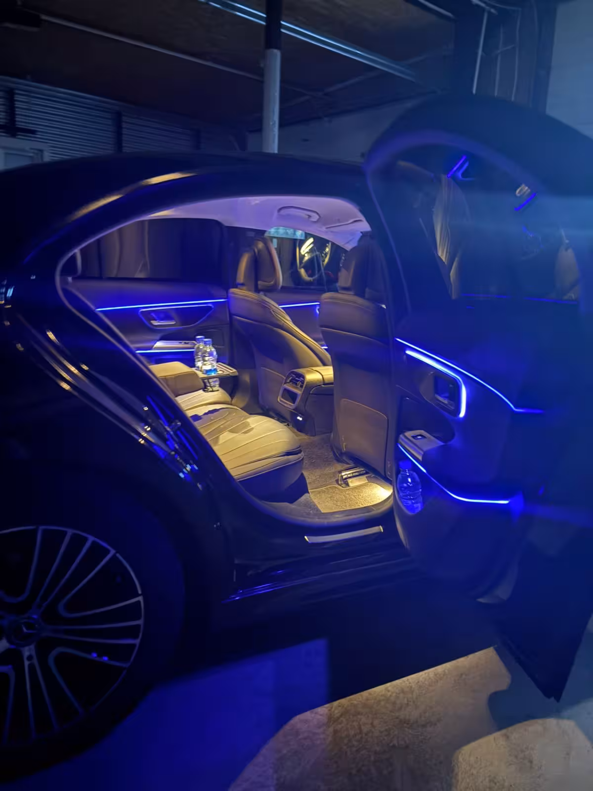 Elegant Mercedes sedan interior with blue ambient lighting and leather seats for a private Reykjavik to Keflavik transfer