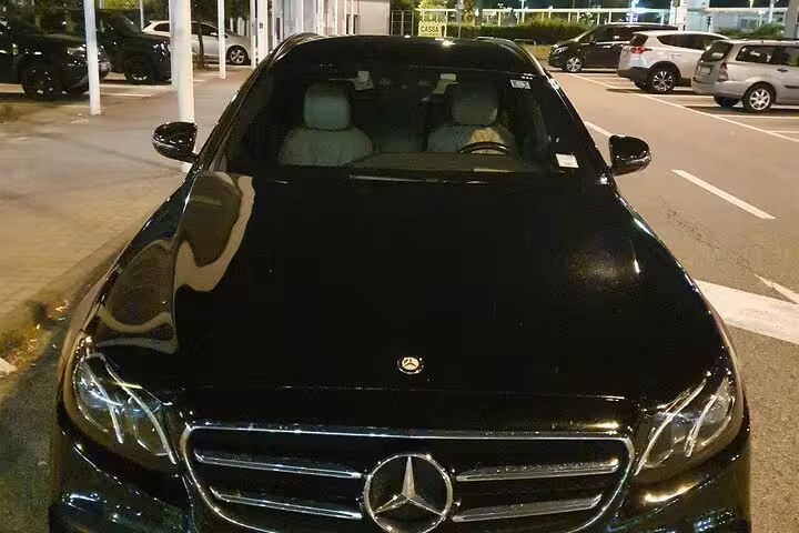 Luxury black Mercedes-Benz sedan parked at Valencia Airport VLC for a private transfer to Valencia city