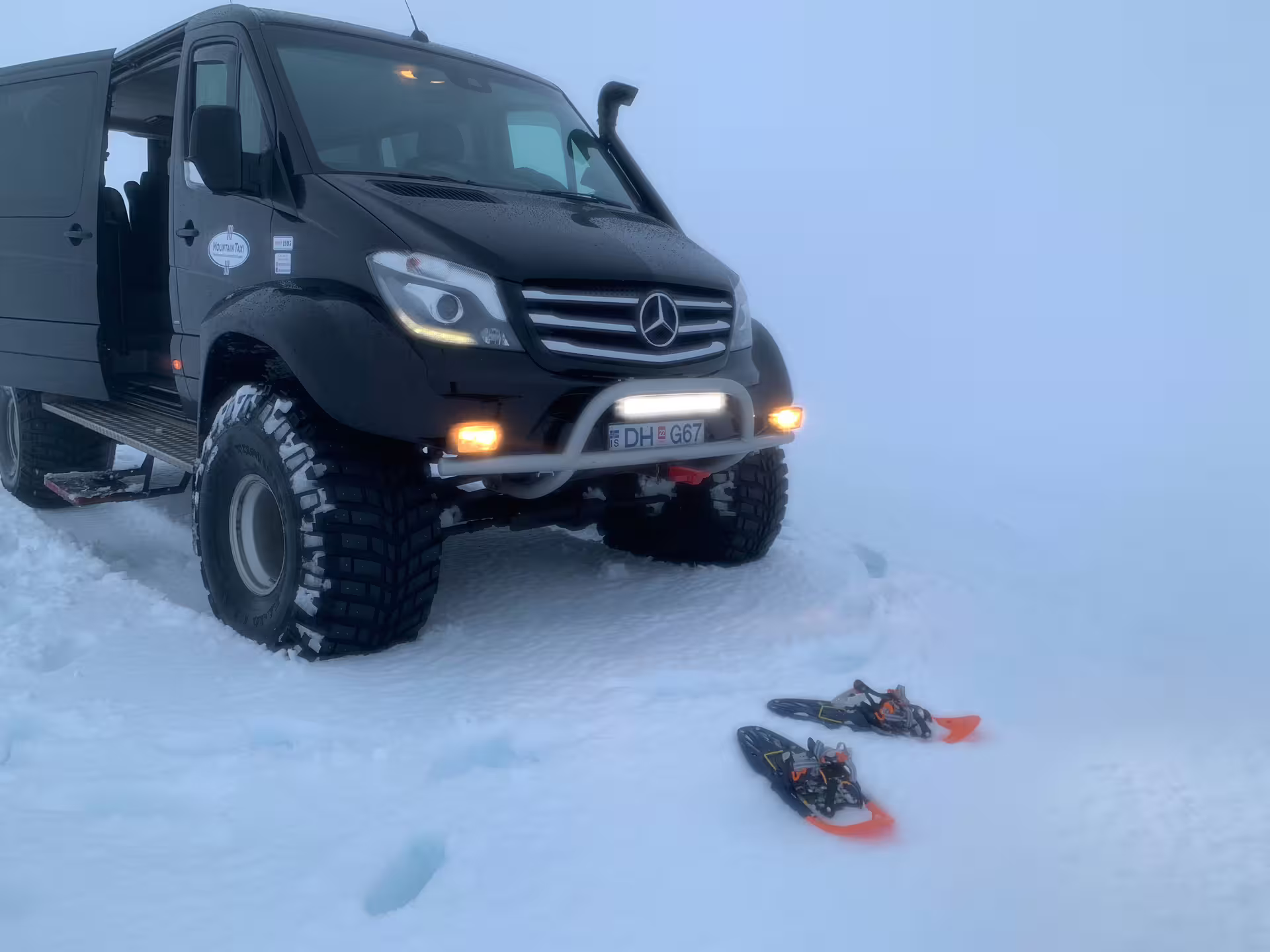 Black Mercedes Sprinter 4x4 super jeep with snowshoes on Langjokull glacier, Iceland
