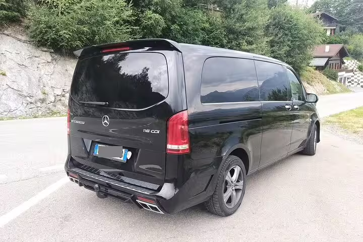 Black Mercedes V-Class private transfer van on a mountain road en route from Oslo Airport to Trysil Ski Resort