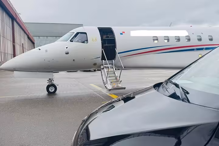 Mercedes V-Class private Zurich Airport transfer beside private jet, luxury chauffeur service pickup