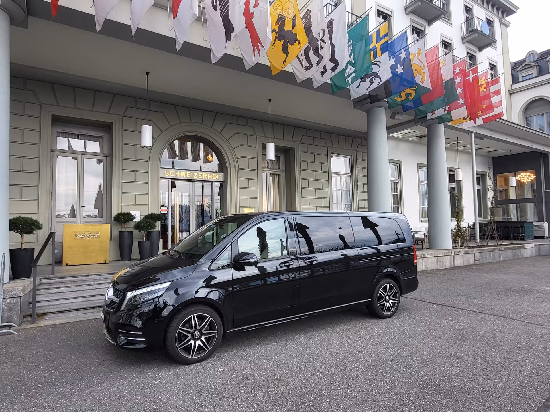 Mercedes V-Class parked outside Schweizerhof Hotel, Zurich, ready for private transfer to Basel.