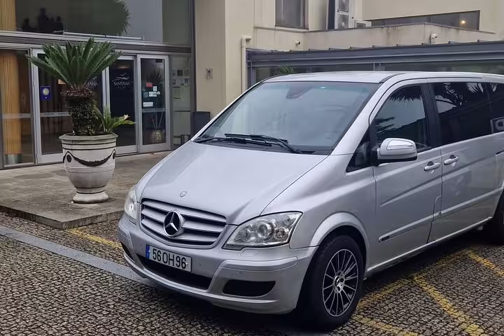 Silver Mercedes van parked at a hotel, ready for a stylish and convenient Algarve to Porto travel experience.