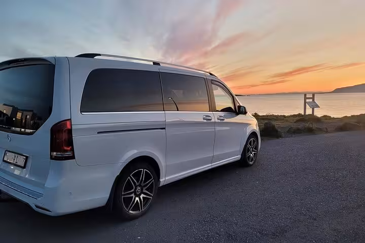 White Mercedes-Benz V-Class van parked near Keflavik coast at sunset for private airport transfer