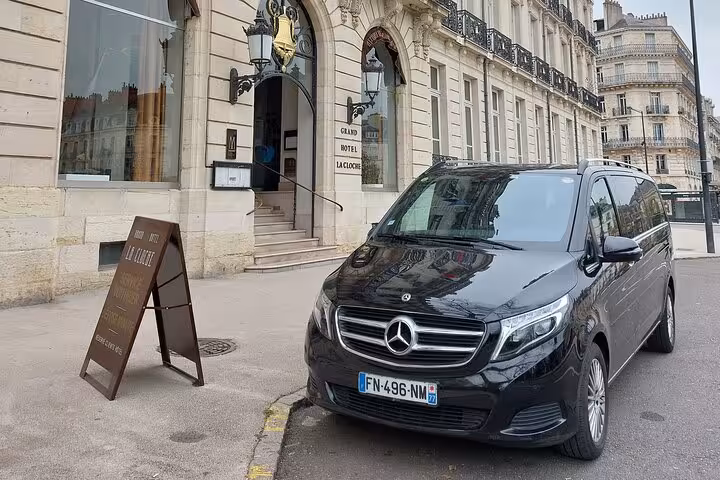 Black Mercedes-Benz V-Class van parked outside Grand Hotel La Cloche in Paris for private transfer