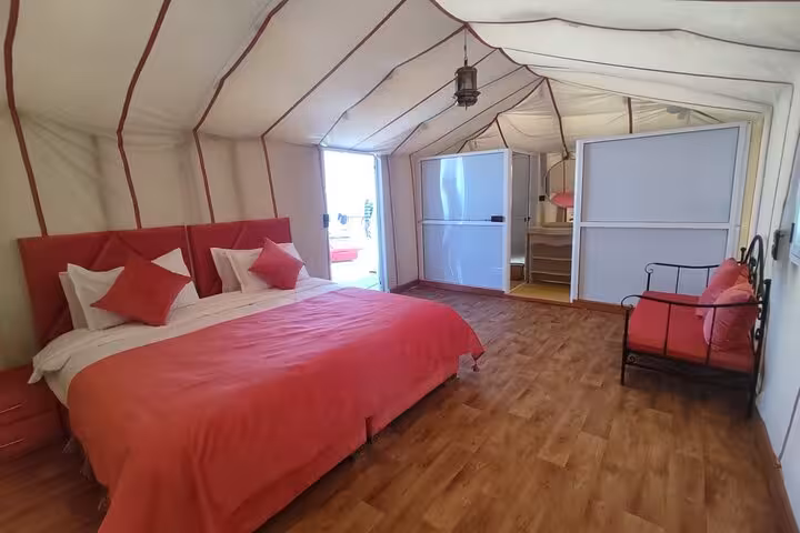 Luxurious desert tent accommodation with plush bedding and elegant decor on Merzouga Desert Tour from Fes.