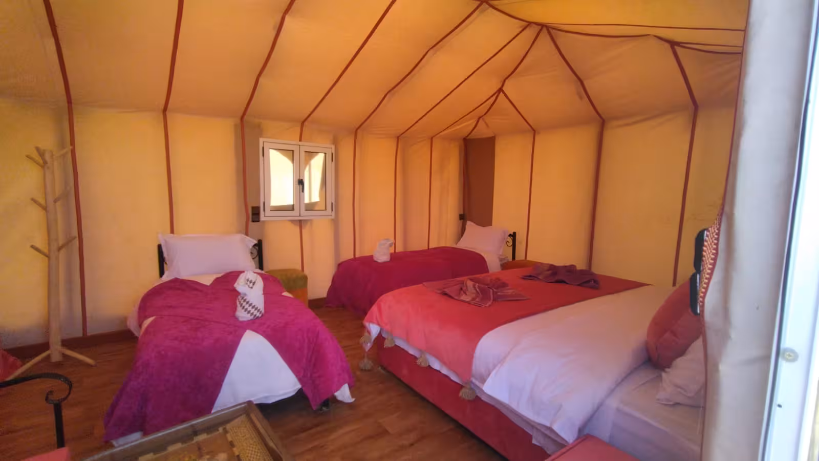 Spacious tent interior with cozy beds and vibrant decor in Merzouga Desert tour from Fes to Errachdia.