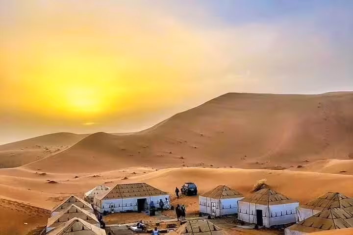 Sunset over Merzouga dunes and Sahara desert camp on 4 days 3 nights Marrakech to Merzouga tour