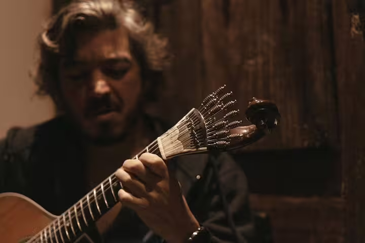 Guitarist performing soulful Fado music at Mesa de Frades, showcasing Portuguese cultural heritage in Lisbon.