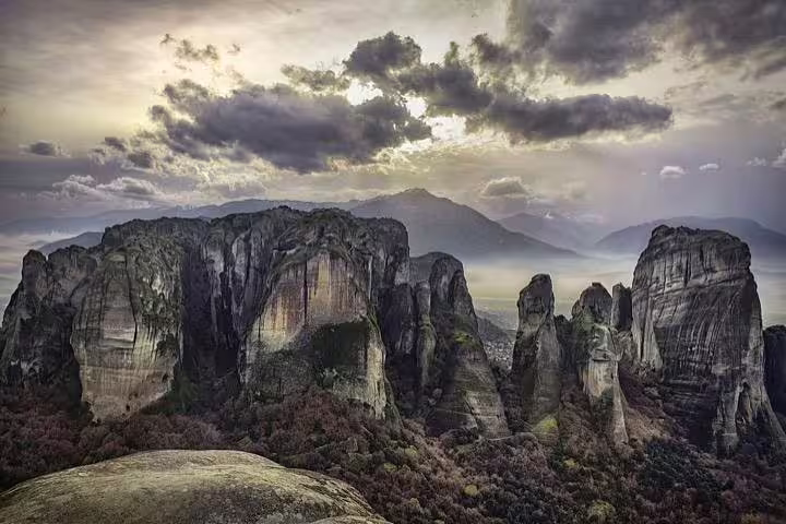 Meteora rock formations near Kalabaka at sunset, scenic start for private transfer to Athens, Greece