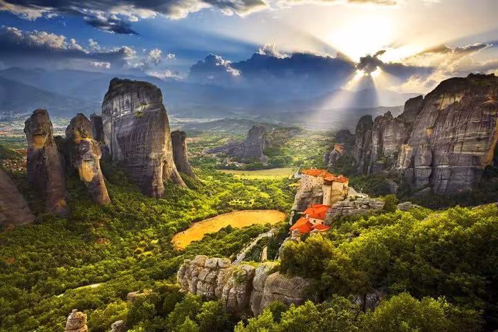 Sunset over Meteora monasteries and rock pillars, scenic stop on a private day trip from Athens, Greece