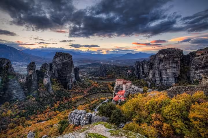 Sunset panorama of Meteora monasteries and dramatic cliffs, highlight of a 2-day luxury private tour from Athens