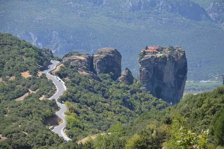Stunning Meteora rock formations with a monastery atop, captured on a private tour from Athens to Delphi and Meteora.