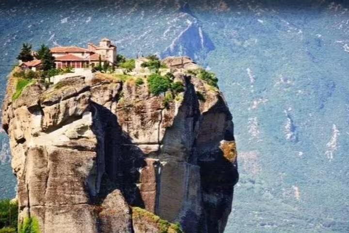 Iconic Meteora cliff-top monastery above dramatic rock pillar, highlight of Athens to Meteora private day trip