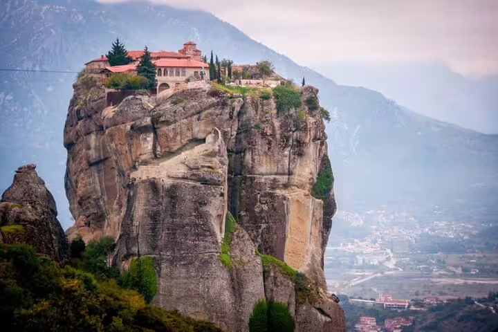 Panoramic view of Meteora cliff-top monastery and valley, highlight of private Meteora day trip from Athens
