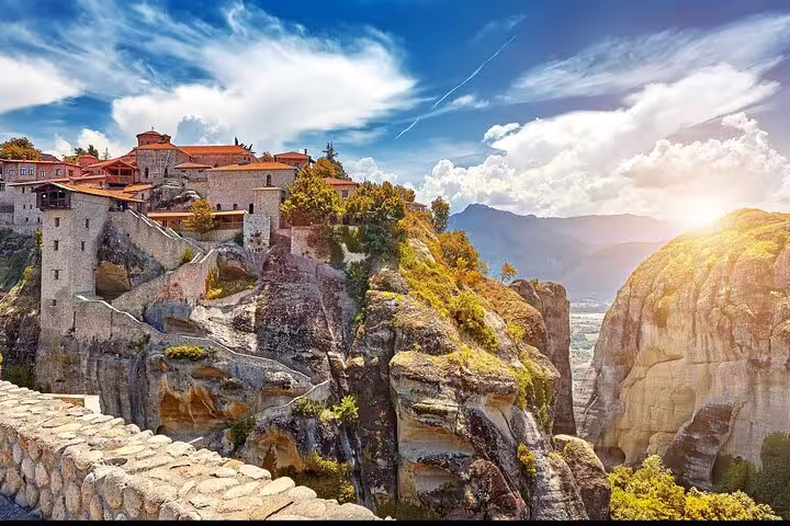 Sunlit Meteora cliffside monastery views on a full-day private Meteora tour from Athens including lunch