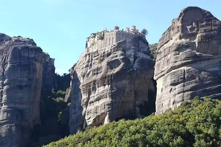 Clifftop Meteora monastery on massive sandstone peak, must-see on full-day Athens tour with dinner