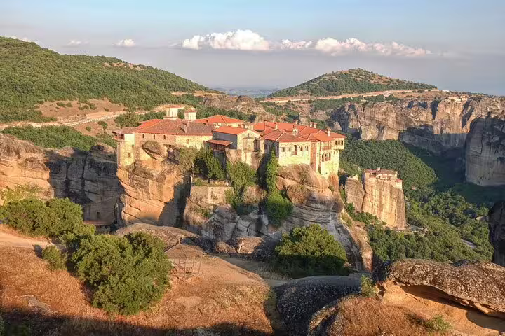 Meteora monastery perched on dramatic rock cliffs, highlight of Delphi and Meteora private day tour from Athens