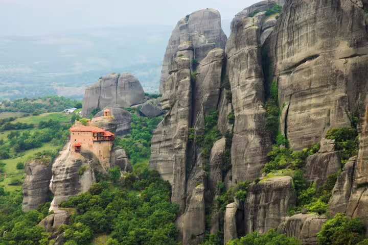 Meteora monastery perched on towering sandstone cliffs, scenic stop on a private day tour from Athens