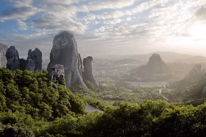 Meteora cliffs at sunrise with monastery view, highlight of 2-day Delphi and Meteora private tour from Athens