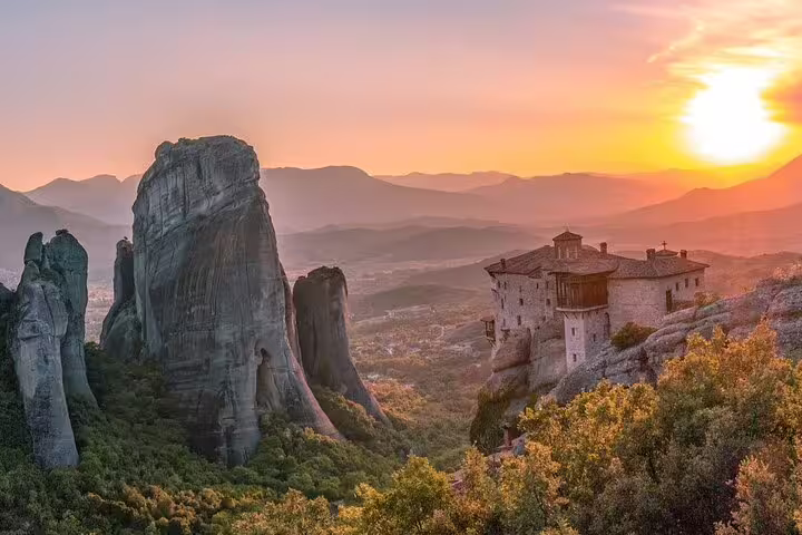 Sunset view of Meteora monastery and towering rock formations, Athens to Meteora private day tour with lunch