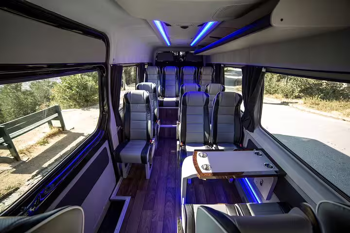 Luxury private minibus interior for Meteora full-day private tour from Athens, comfortable seats and onboard table
