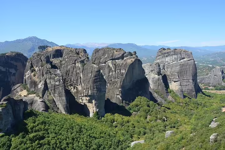 Stunning rock formations of Meteora surrounded by lush greenery, part of the two-day tour from Athens.