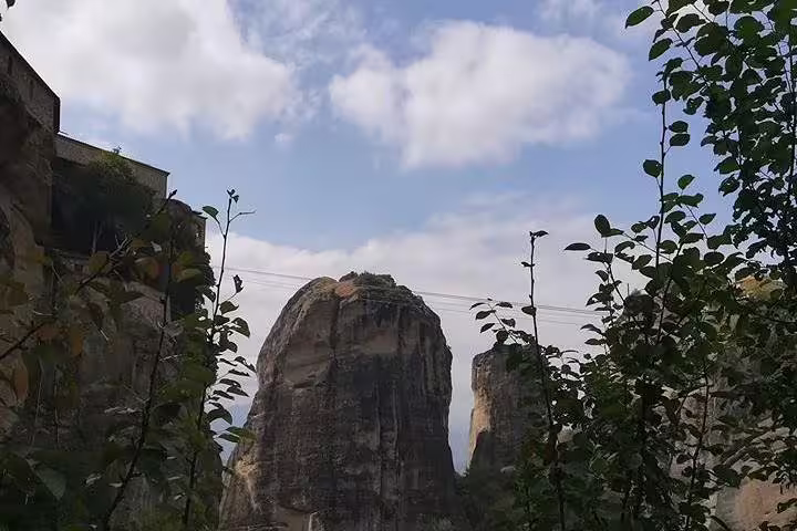 Meteora rock pillars framed by greenery on full-day tour from Athens to Meteora and Vergina with dinner