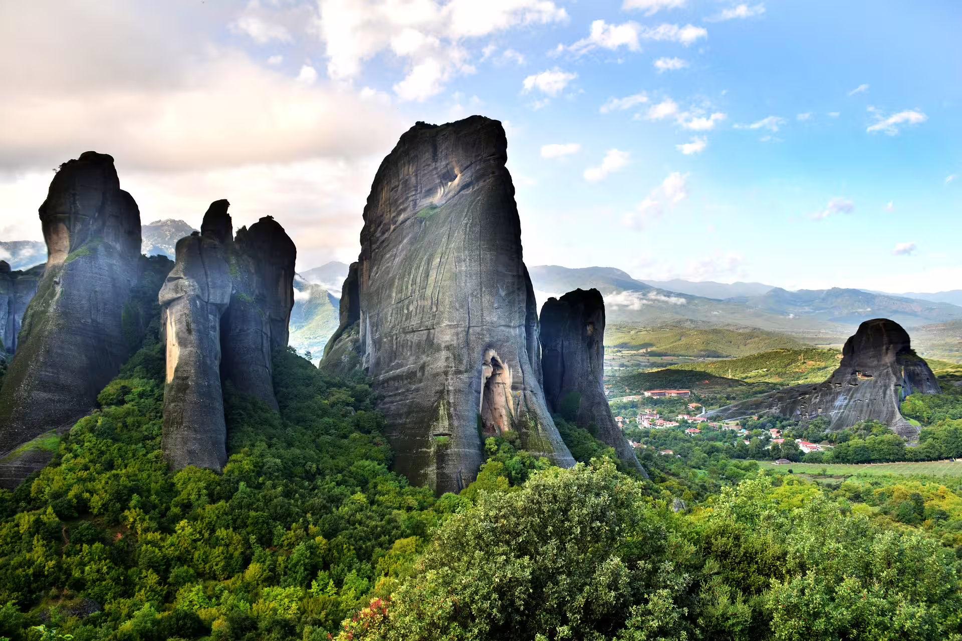 Meteora rock towers above lush valley near Kalambaka, scenic stop on 2-day private tour from Athens