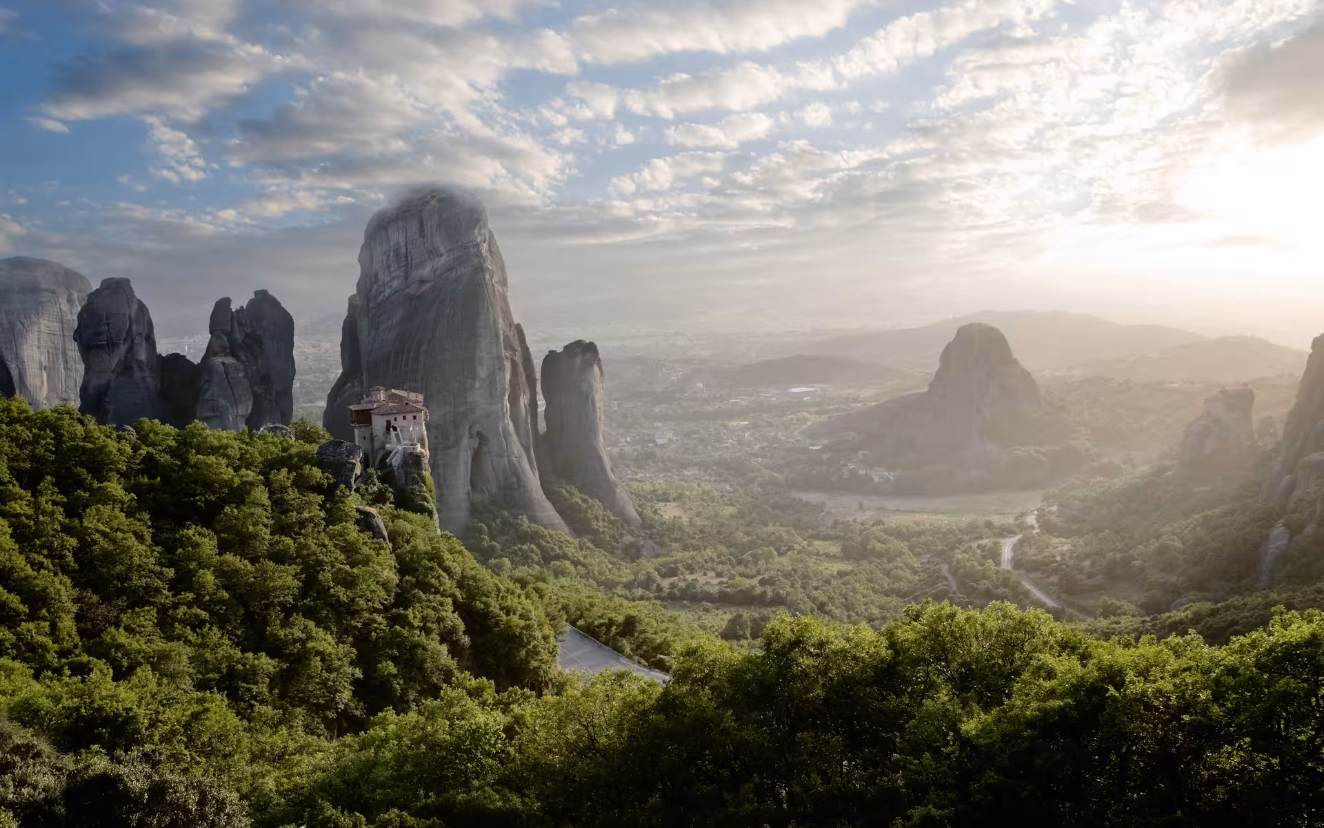 Sunrise over Meteora rock pillars and cliffside monastery, highlight of a 2 day Delphi & Meteora tour