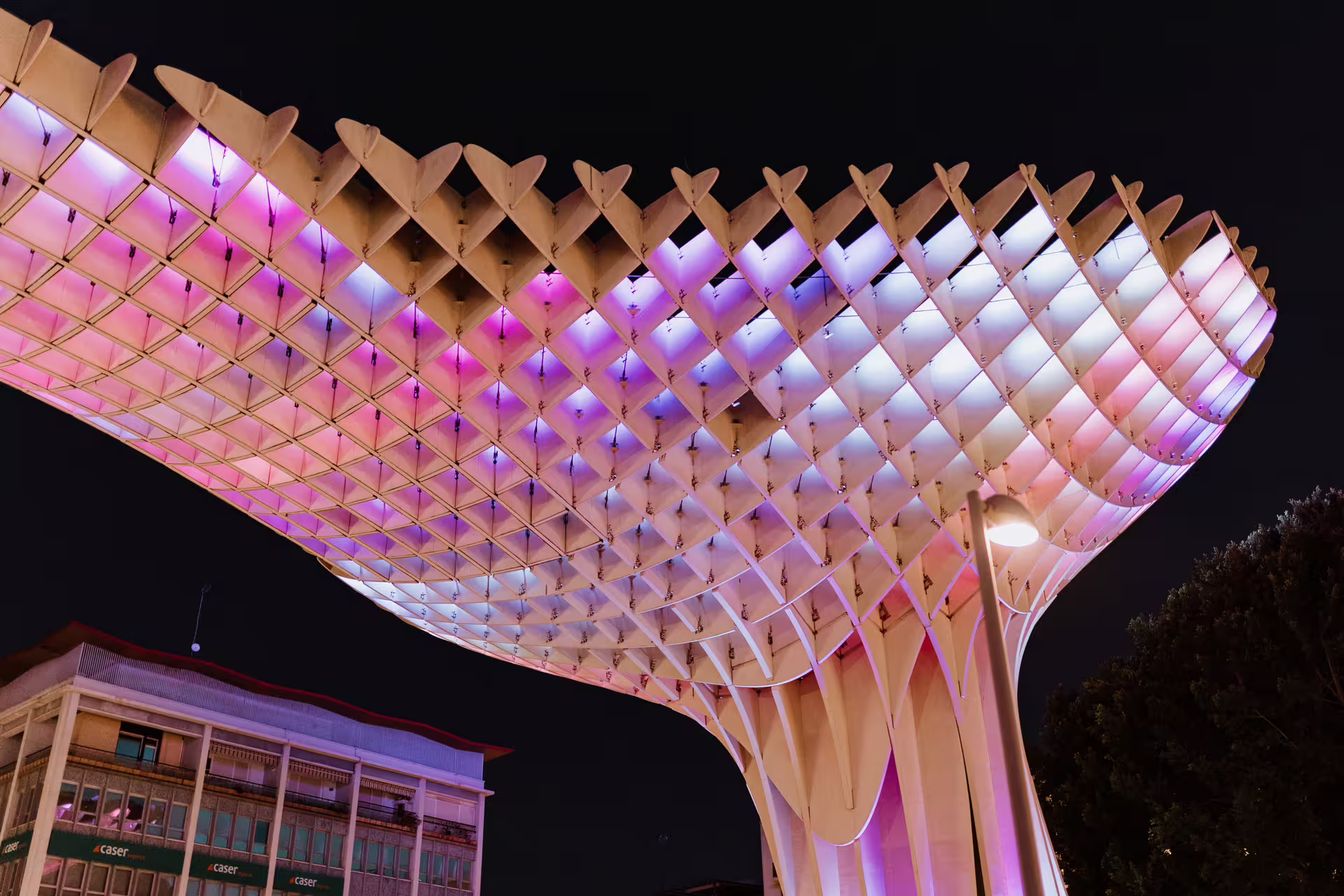 Illuminated Metropol Parasol at night, Seville's architectural marvel, featured on the Mysterious and Paranormal Tour.