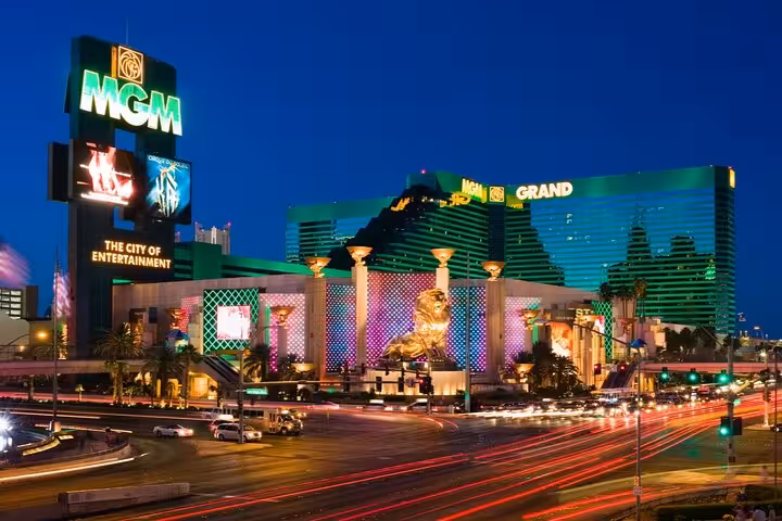 MGM Grand Hotel and Casino illuminated at night on the Las Vegas Strip with light trails from traffic