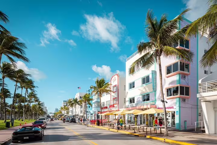 Art Deco buildings and palm trees lining Ocean Drive in Miami Beach on a sunny day