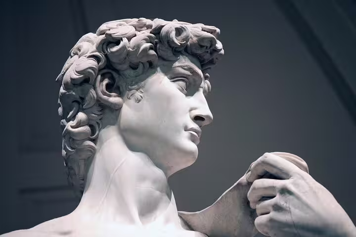 Close-up of Michelangelo’s David in Florence’s Accademia Gallery, highlighting detailed sculpture seen on a live guided tour