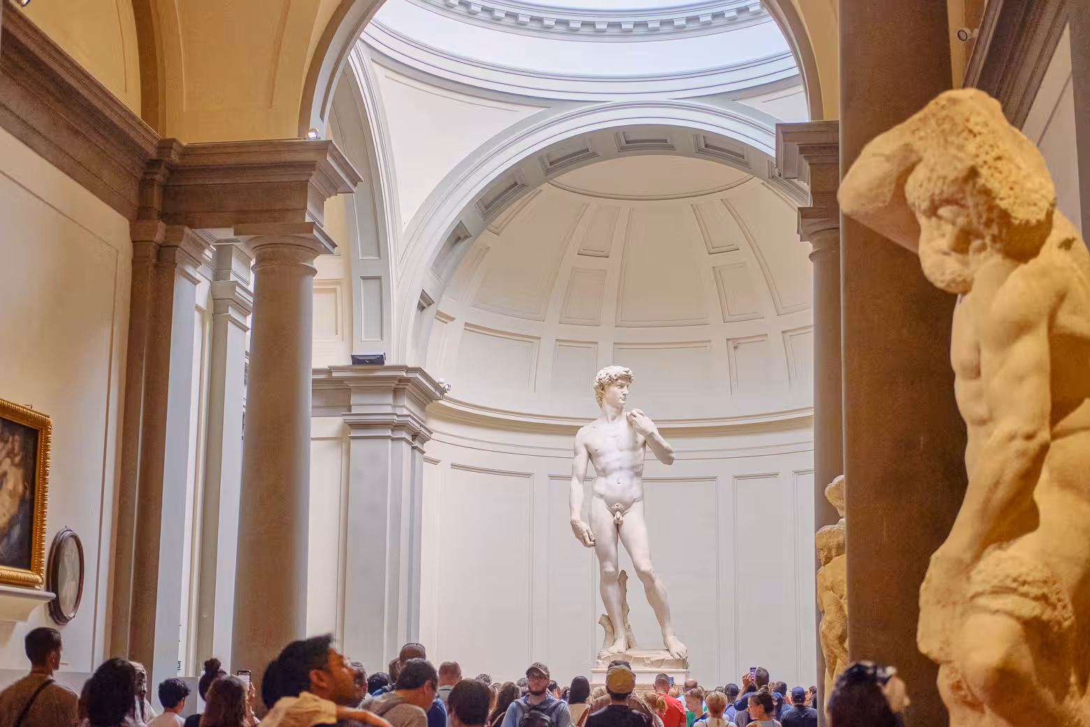 Crowds gather around Michelangelo's David during a guided skip-the-line tour at Florence's Accademia Gallery.