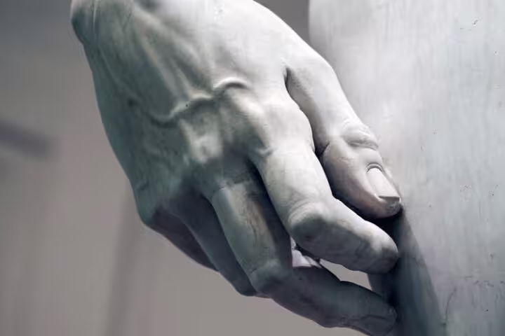 Close-up detail of Michelangelo’s David hand sculpture in Florence’s Accademia Gallery on a live expert-led guided tour