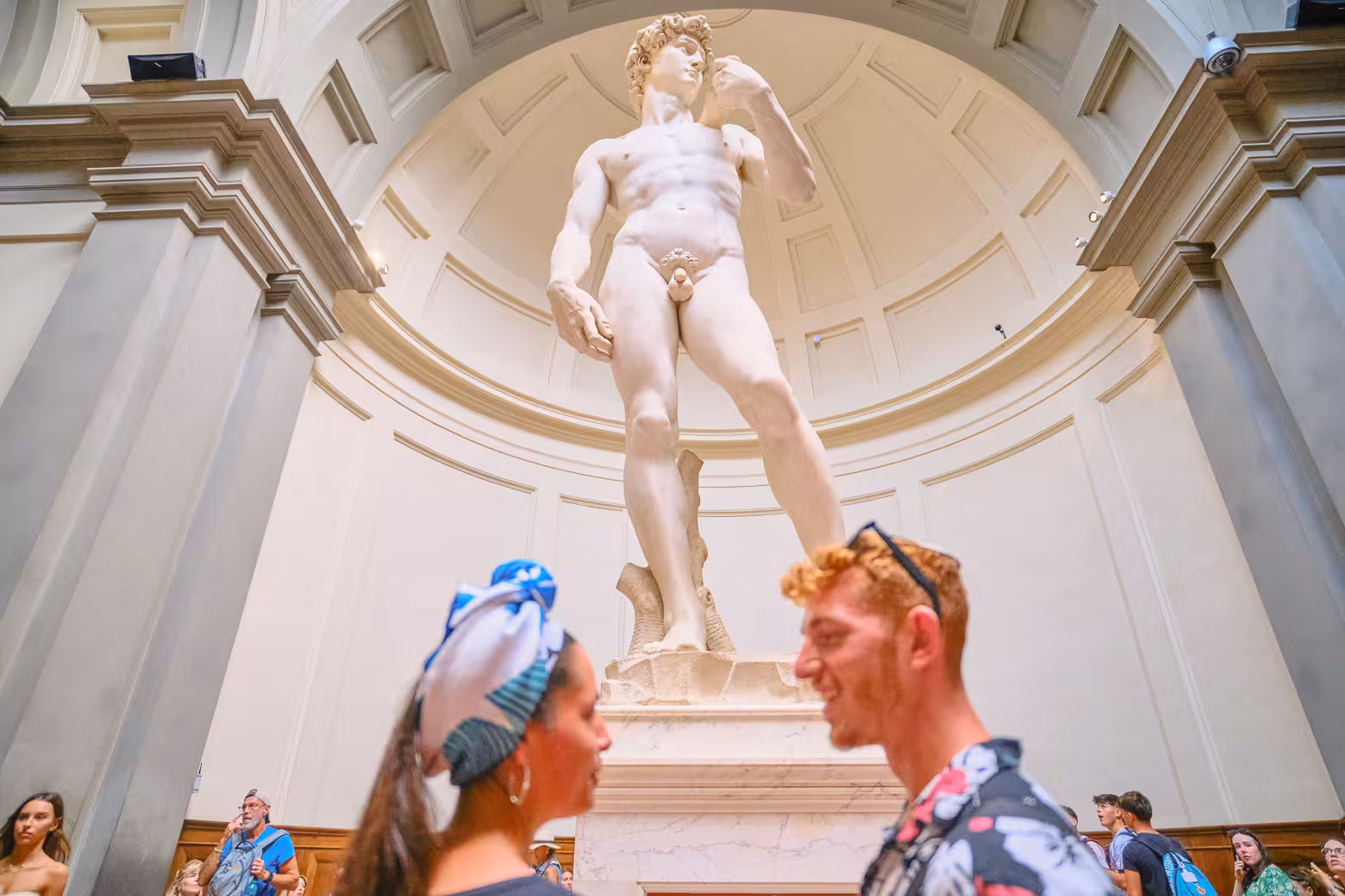 Visitors admire Michelangelo's David during a guided tour at Florence's Accademia Gallery, skipping the line.