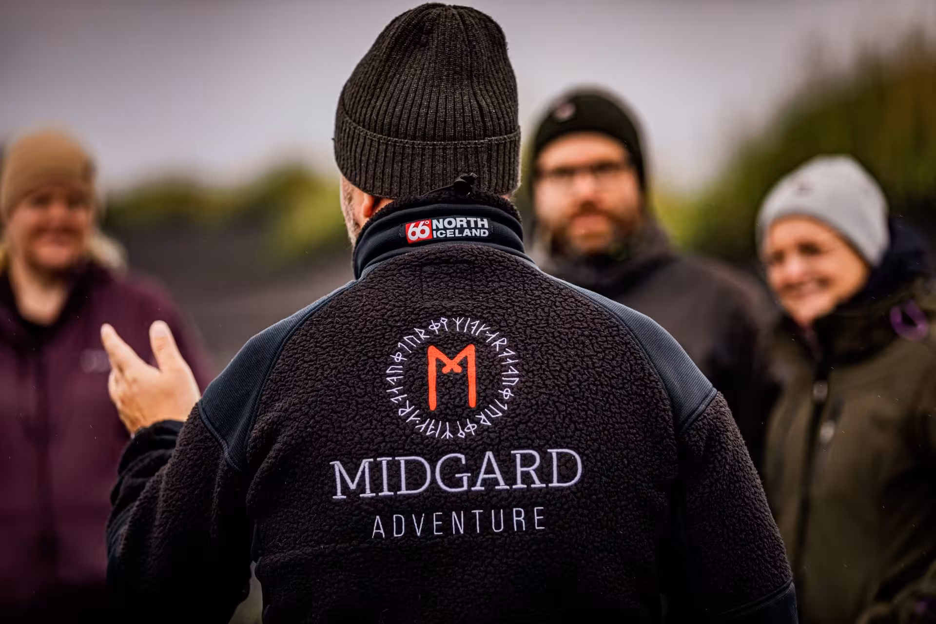 Midgard Adventure guide in black fleece jacket briefing guests for a super jeep tour in Iceland