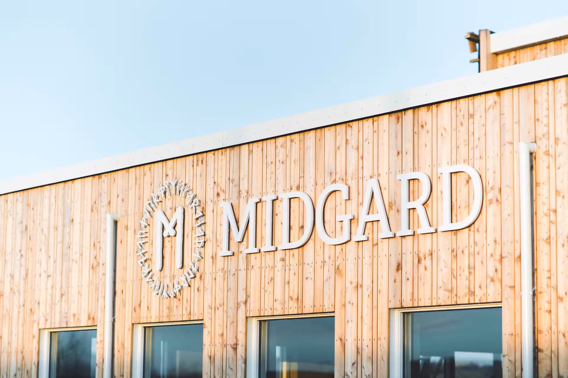 Midgard base camp wooden building exterior with logo sign, Iceland