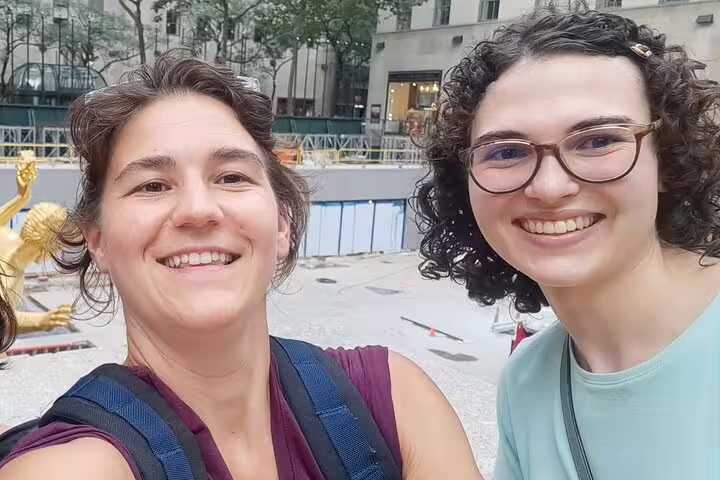 Two smiling women taking a selfie at Rockefeller Center during a Midtown Manhattan walking tour