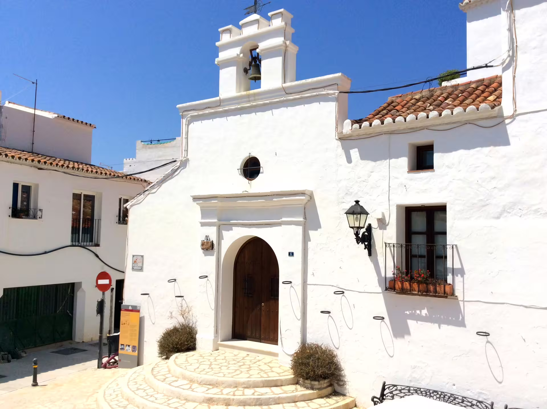 Whitewashed Mijas Pueblo chapel facade under blue sky on a private full-day trip from Marbella with pickup
