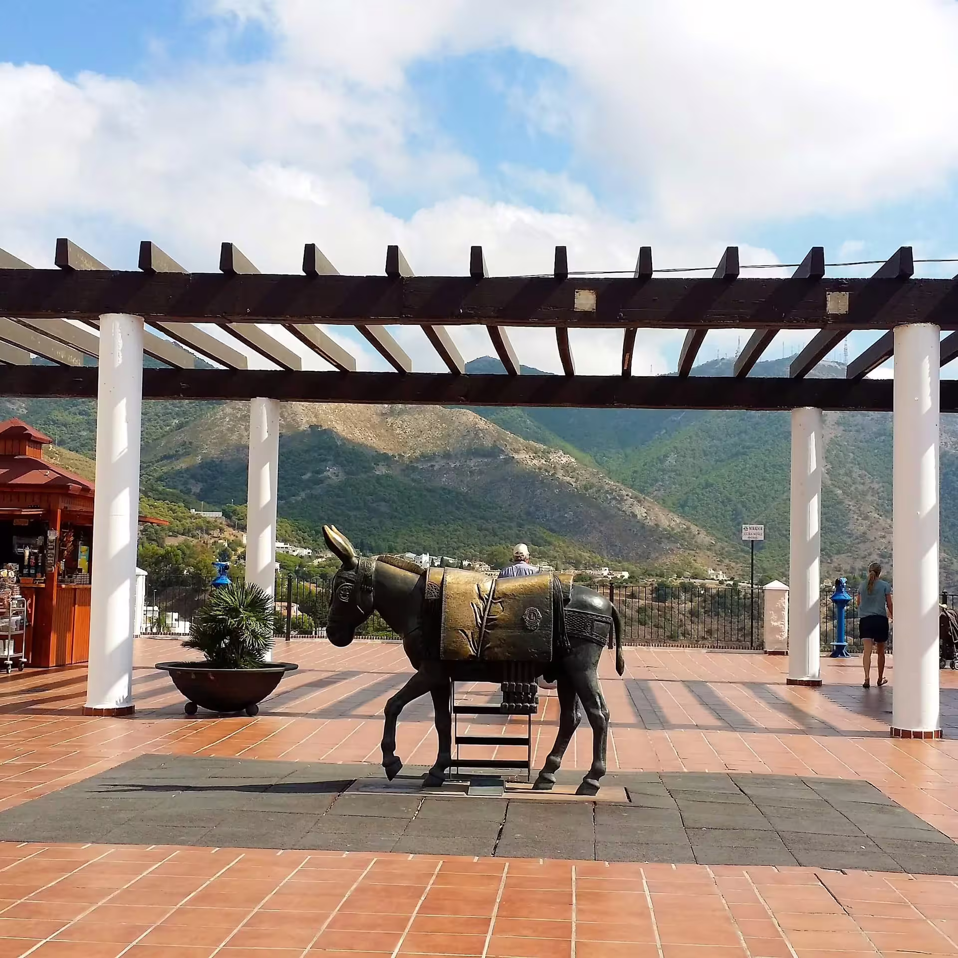 Donkey statue under pergola with mountain views in Mijas Pueblo on guided group walking tour, Costa del Sol