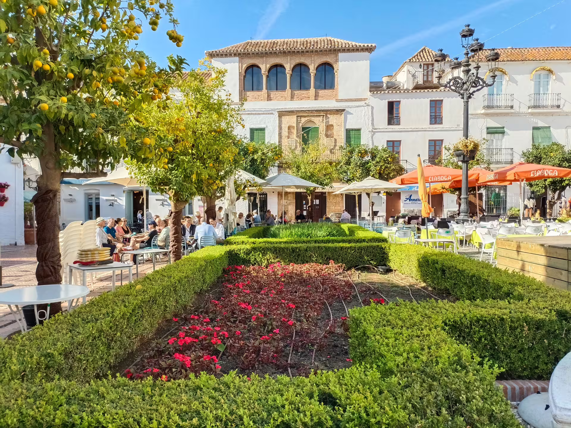 Mijas Pueblo plaza with orange trees and outdoor cafés, stop on Marbella & Mijas private full-day trip