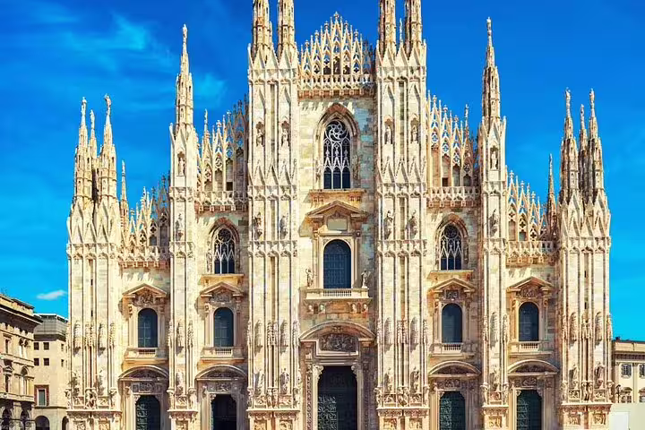 Marvel at the stunning architecture of Milan Cathedral under a clear blue sky on our private full-day Milan tour.