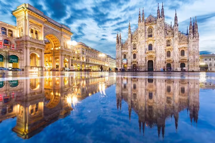 Milan Duomo Cathedral and Galleria Vittorio Emanuele II reflected in wet piazza at dusk