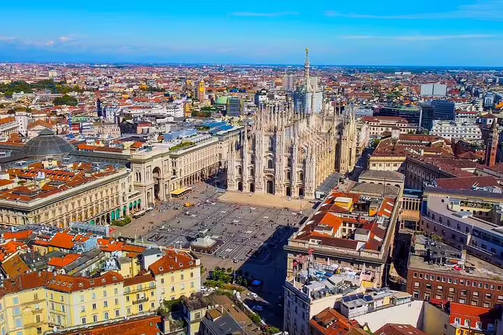 Aerial view of Milan Cathedral Duomo and Piazza del Duomo surrounded by city rooftops